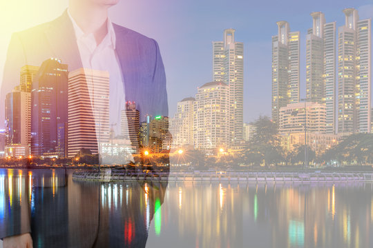 Businessman in Suit with City Background with Double Exposure Illustrating Business Leadership Concept