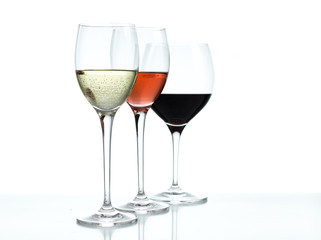 Glasses of red, white and rose wine on a white background