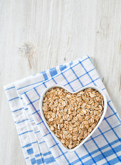spelt flakes on wooden surface