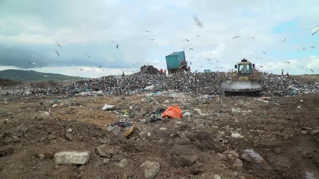 Landfill dump with graders and bulldozer