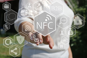 The businesswoman clicks on the NFC  icon on the touch screen the web network.