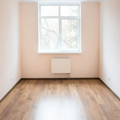 Empty room with window and wooden floor
