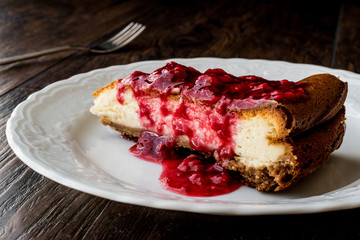 Homemade Raspberry Cheesecake in white plate.