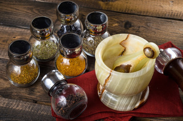 spices in Jar with mortar on wodeen background