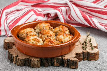 Stuffed mushrooms, baked with cheese in a ceramic form
