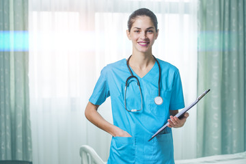 woman doctor or nurse standing in hospital room