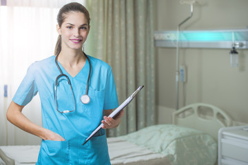 woman doctor or nurse standing in hospital room