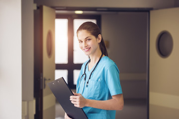 woman doctor or nurse is standing in a hospital corridor