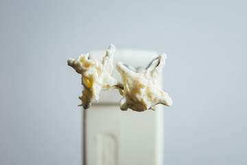 Mixer on kitchen after beating up a cream. Horizontal studio shot.