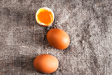 Hard boiled eggs with orange yolk in rustic style  on wooden background close up