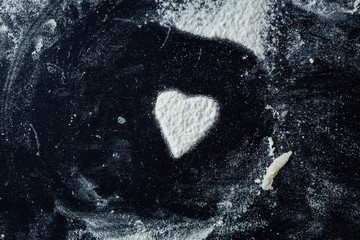 Heart flour trace on a kitchen. Horizontal studio shot.
