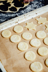 Shaped cookies waiting for being baked on a baking pan. 