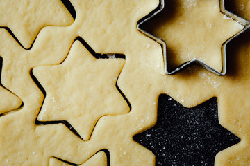 The raw cookies lying on a kitchen table. Horizontal studio shot.