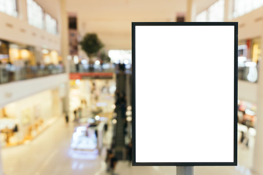 Blank mock up of vertical poster billboard sign with copy space for your text message or content in modern shopping mall.