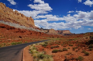 Road along a tilted geologic fold. Waterpocket Fold, Capitol Reef National Park. Navajo Sandstone formation. Sedimentary strata: soft red Chinle Formation, hard red Navajo Sandstone, grey Mancos Shale