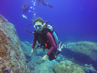 Naklejka na ściany i meble Underwater scuba diving selfie shot with selfie stick. Deep blue sea. Wide angle shot.