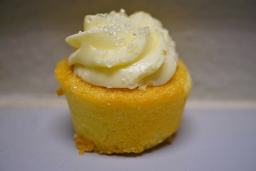 Mini lemon cupcake with white buttercream frosting