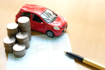 Coins stack in columns, saving book, car. Finance and banking co