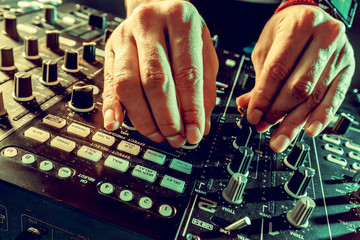 DJ playing music at mixer closeup