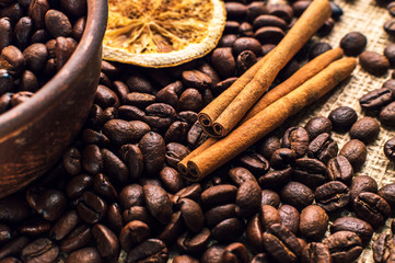 Coffee beans into bowl with cinnamon and anise