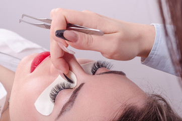 Business woman or girl enjoys salon and upgraded eyelashes, she