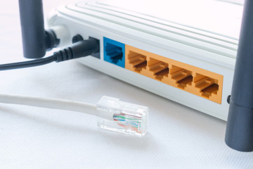 internet cable and a router on a white background
