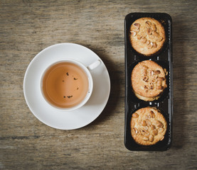 cup of hot tea and biscuits with peanuts top view
