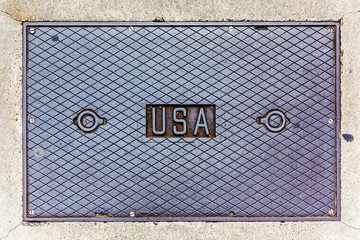 USA lettering on a steel manhole cover.