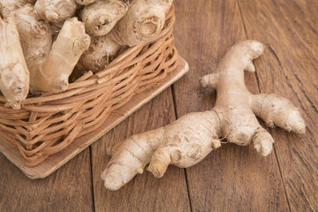 Ginger roots on wooden background (Zingiber officinale)