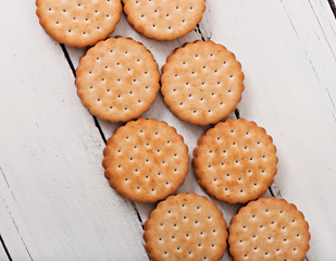Tasty baked cookies on old wooden background.