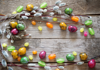 Naklejka na ściany i meble Easter eggs and willow branches on wooden background