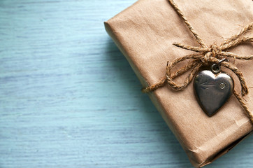 Valentines Day gift with vintage silver heart on a blue wooden background.Valentine's Day background.Saint Valentine's Day or Love concept.Copy space.Selective focus.