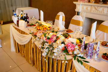 the table of the newlyweds decorated with flowers