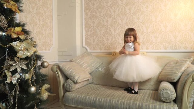 The large sofa in the lush dress a little girl spinning like a ballerina