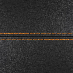 Fototapeta premium black leather background with orange stitching