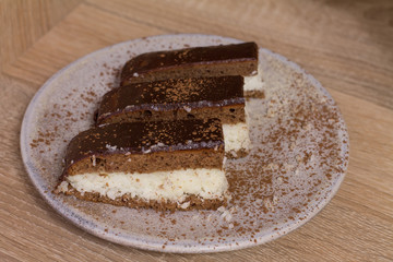 Chocolate cake `Bounty`  with coconut on wood background