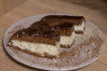 Chocolate cake `Bounty`  with coconut on wood background