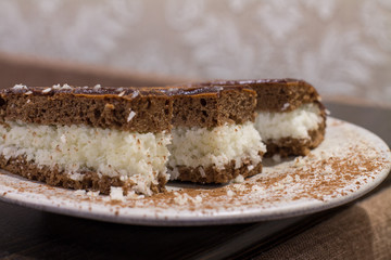 Chocolate cake "Bounty"  with coconut on plate. 