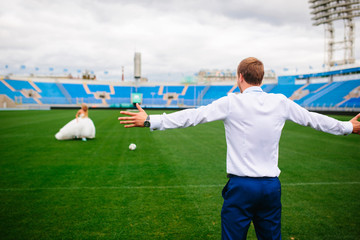 The bride and groom playing football, fun at the wedding