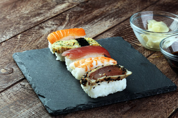 close up of sashimi sushi set with chopsticks and soy - sushi roll with salmon and sushi roll with smoked eel, selective focus.