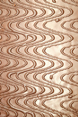 Fototapeta na wymiar Brown chocolate abstract pattern as background front view vertical closeup