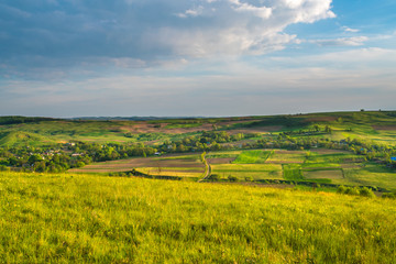 The beautiful meadow on the background of cloud. Wide angle