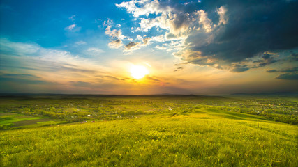 Fototapeta premium The picturesque field on the background of sunrise. Wide angle