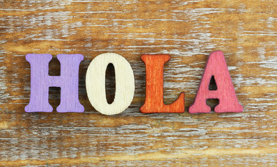Hola (Hello in Spanish) written with colorful wooden letters   © graletta