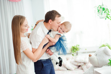 Lovely family smiling and laughing, posing at camera, and huggin