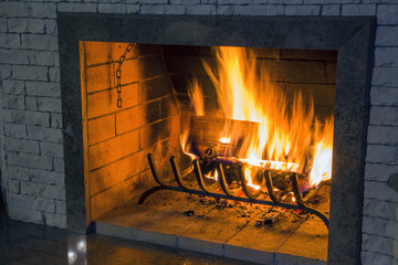 Fire in fireplace, firewood burns in a fireplace. Fireplace in a country house.