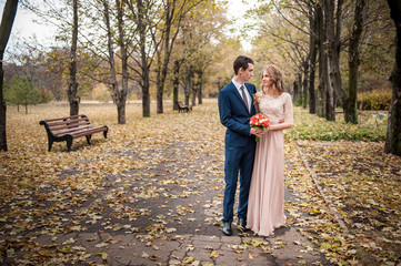 Fototapeta premium Bride and groom hugging in a forest in the autumn forest, weddin