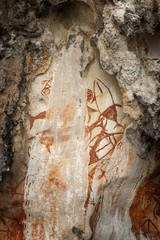 Preshistoric petroglyph rock paintings in Raja Ampat, West Papua, Indonesia. Aborigines from Australia left their markings in the form of rock paintings in and around Misool Island in Raja Ampat.