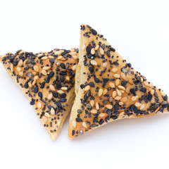 Crisps with nuts and seeds stacked on a white background.