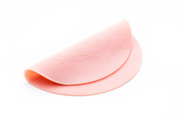 Fototapeta premium Sliced boiled ham sausage isolated on white background, top view